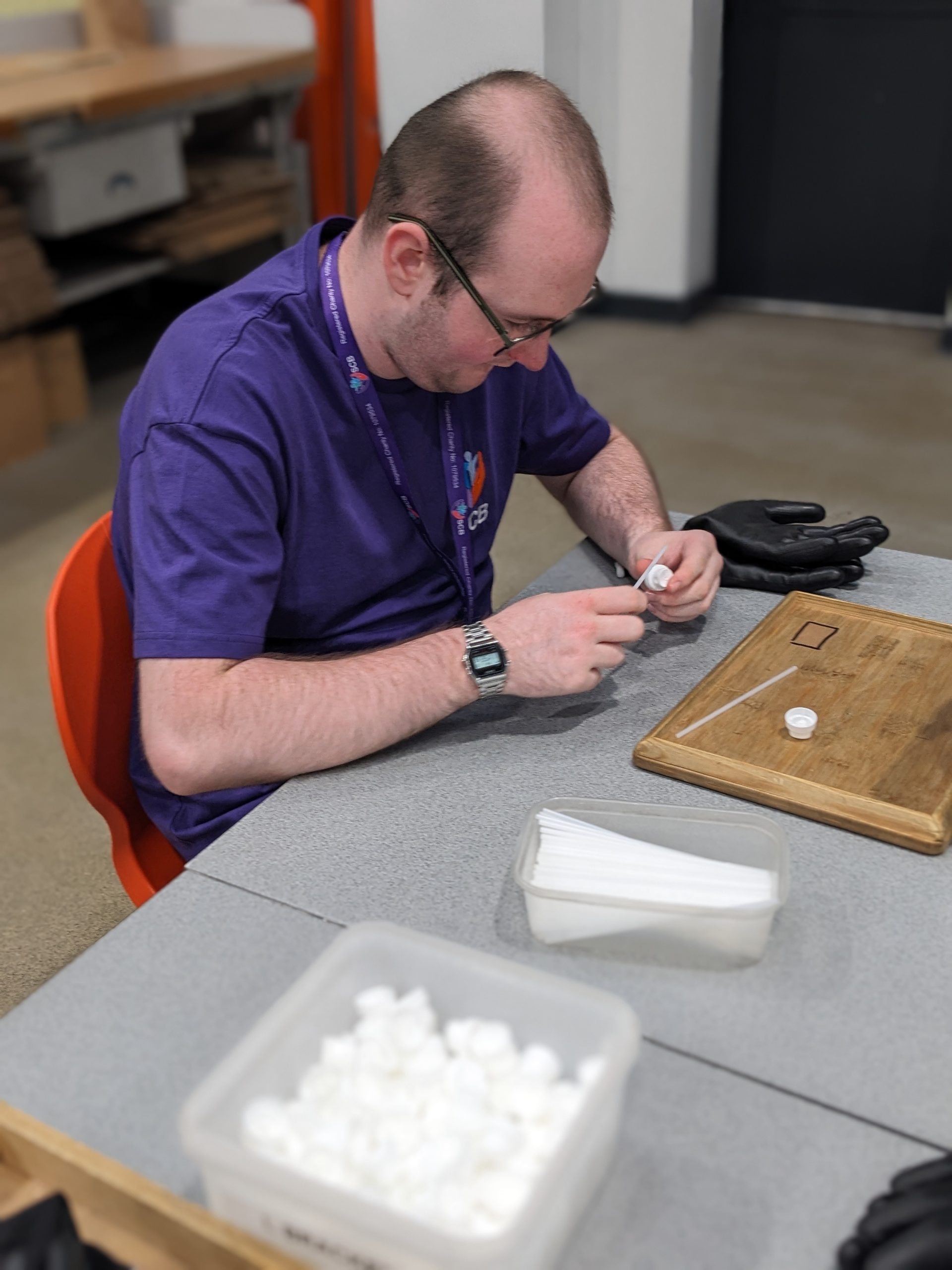 SCB trainee completing a practical task with staff support